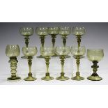 A mixed group of mostly olive tinted and other coloured glasses and glassware, 19th and 20th