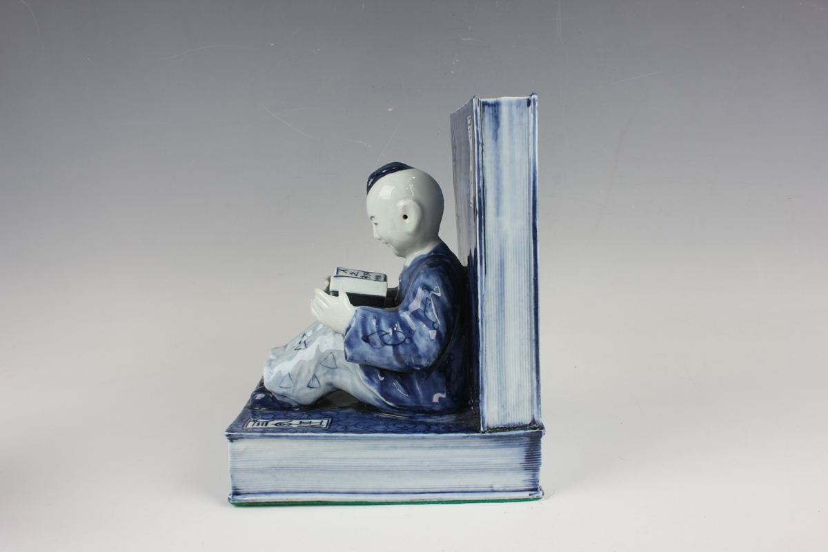 A pair of Chinese blue and white porcelain bookends, each modelled with a seated boy or girl reading - Image 7 of 18