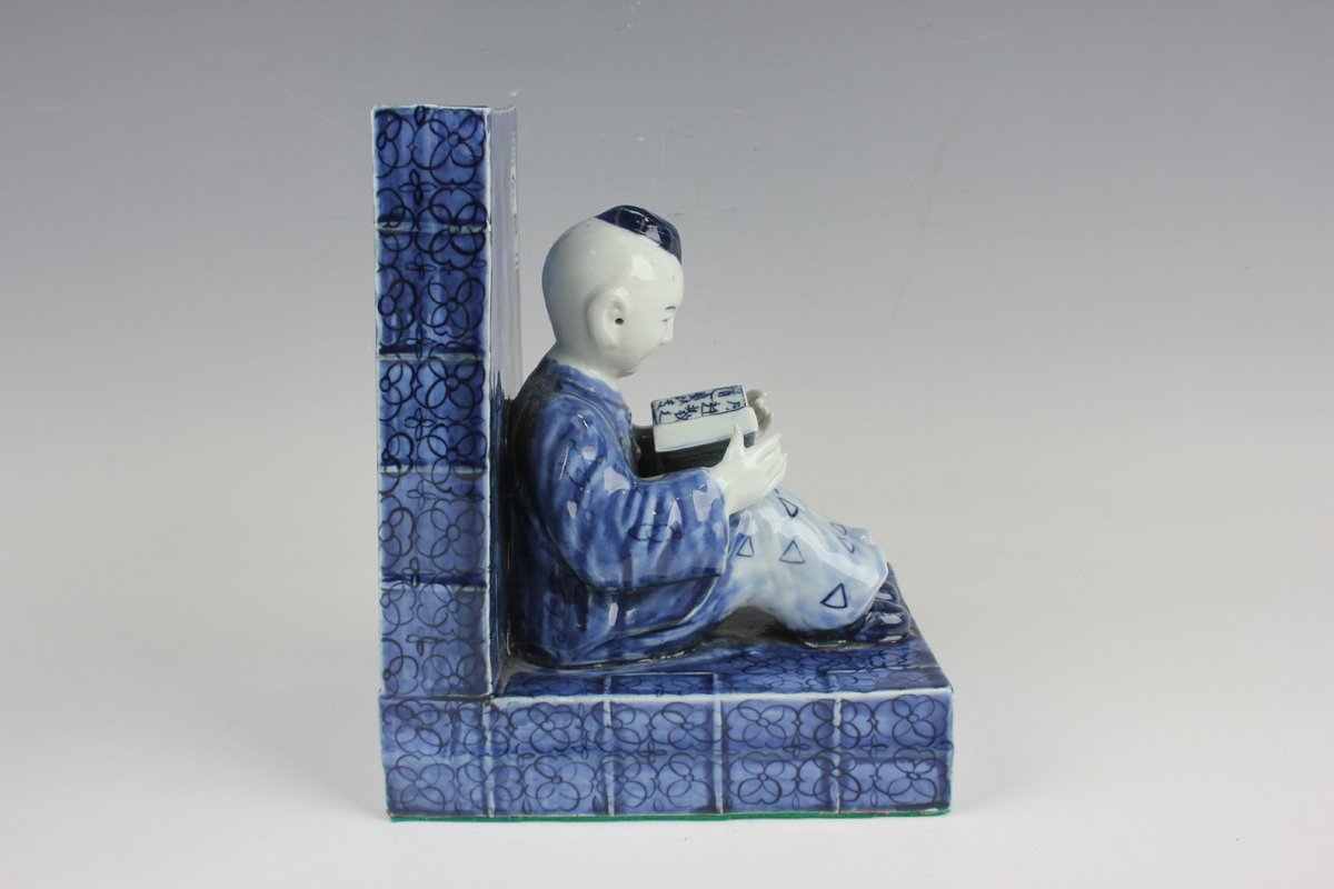 A pair of Chinese blue and white porcelain bookends, each modelled with a seated boy or girl reading - Image 9 of 18