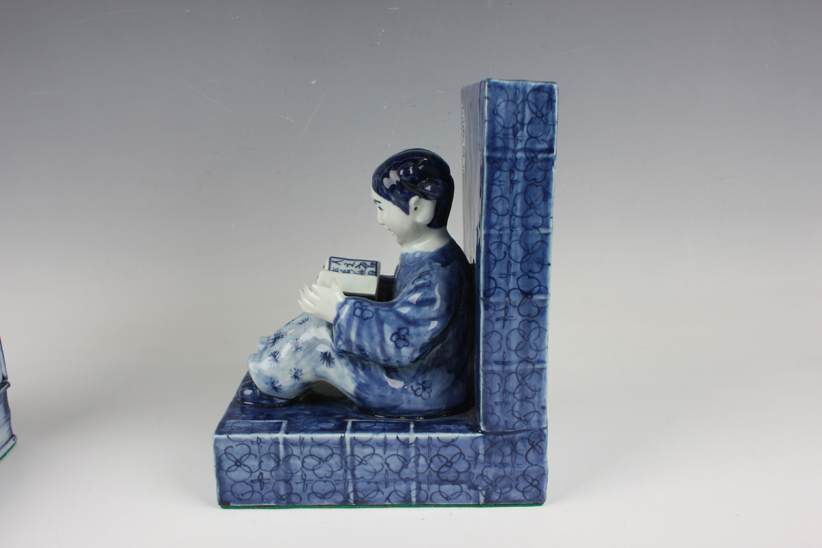 A pair of Chinese blue and white porcelain bookends, each modelled with a seated boy or girl reading - Image 16 of 18