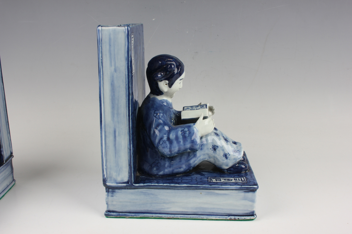 A pair of Chinese blue and white porcelain bookends, each modelled with a seated boy or girl reading - Image 14 of 18