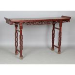 A Chinese hardwood altar table, modern, the rectangular panelled top with scroll ends above a carved