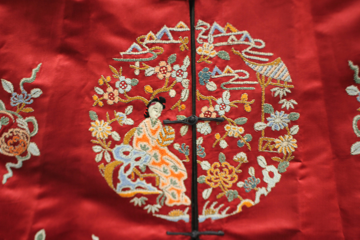 A Chinese red silk embroidered coat/robe, 20th century, worked in coloured threads with figure and - Image 19 of 19