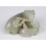 A Chinese pale celadon jade figure group of a recumbent ram and lamb, probably 20th century,