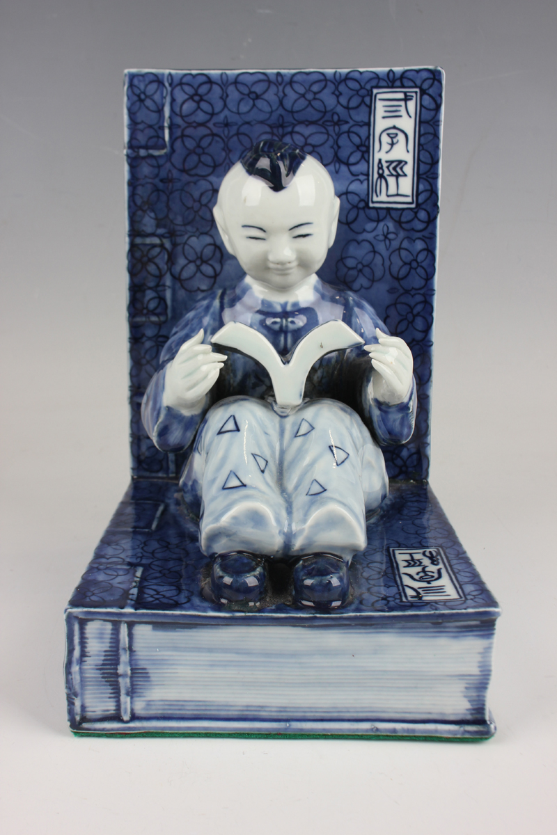 A pair of Chinese blue and white porcelain bookends, each modelled with a seated boy or girl reading - Image 11 of 18