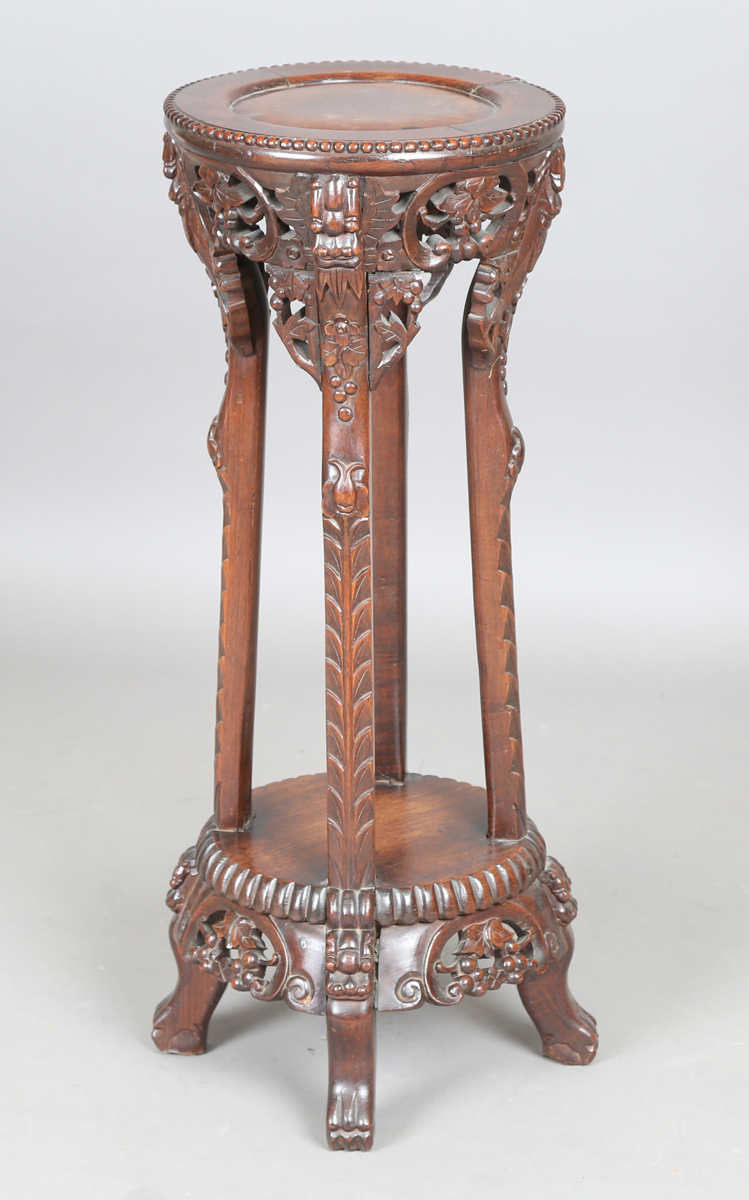 A Chinese hardwood jardinière stand, early 20th century, the circular top with beaded border above a