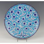 A Multan tin glazed earthenware circular dish, 19th century, painted with blue and white