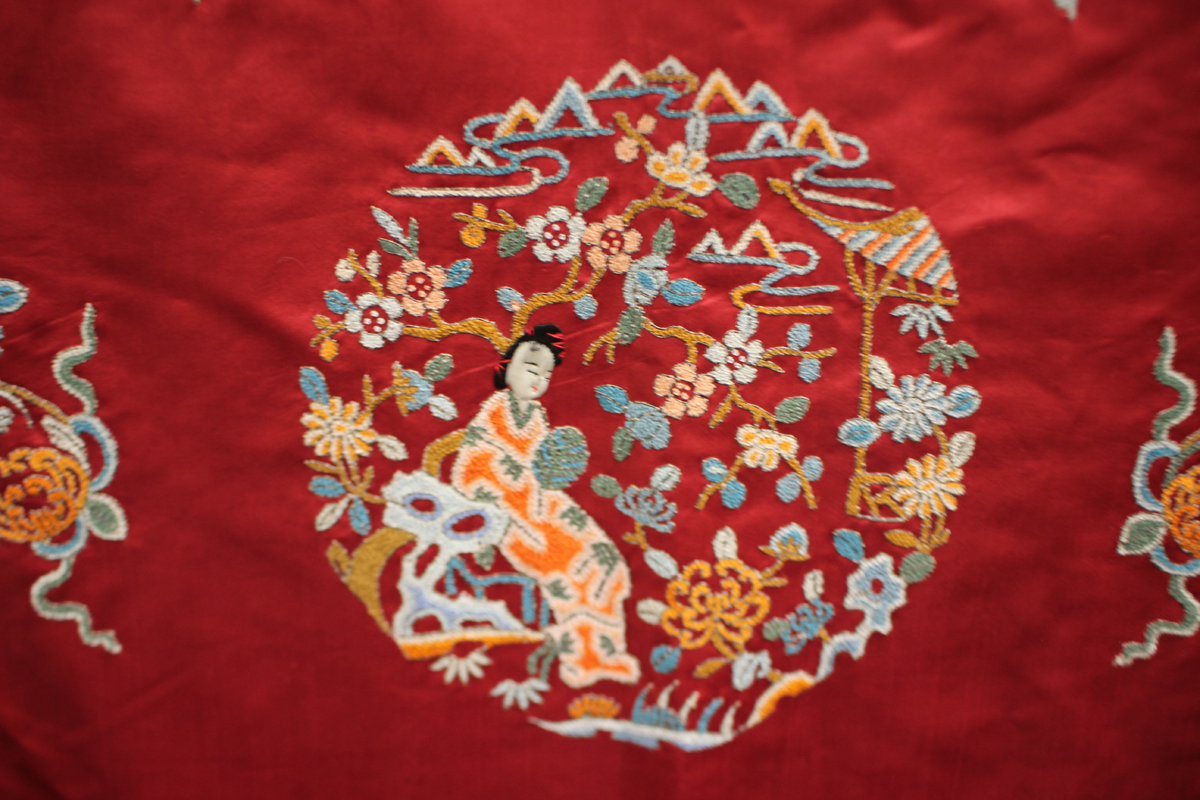 A Chinese red silk embroidered coat/robe, 20th century, worked in coloured threads with figure and - Image 9 of 19