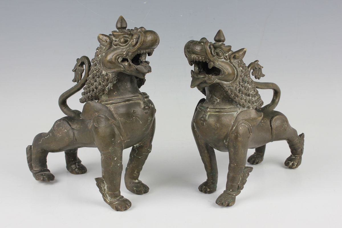A pair of South-east Asian bronze models of Buddhistic lions, probably Nepalese, late 19th