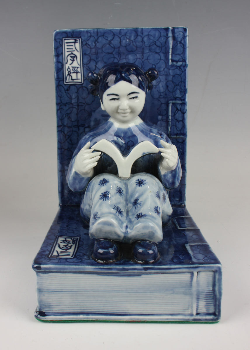 A pair of Chinese blue and white porcelain bookends, each modelled with a seated boy or girl reading - Image 18 of 18