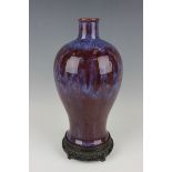 A Chinese flambé glazed porcelain vase, late Qing dynasty, of baluster form, covered in a streaky