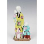 A Chinese famille rose enamelled biscuit porcelain figure group, 18th century, modelled as a