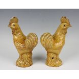A pair of Chinese yellow glazed porcelain models of cockerels, early 20th century, each modelled