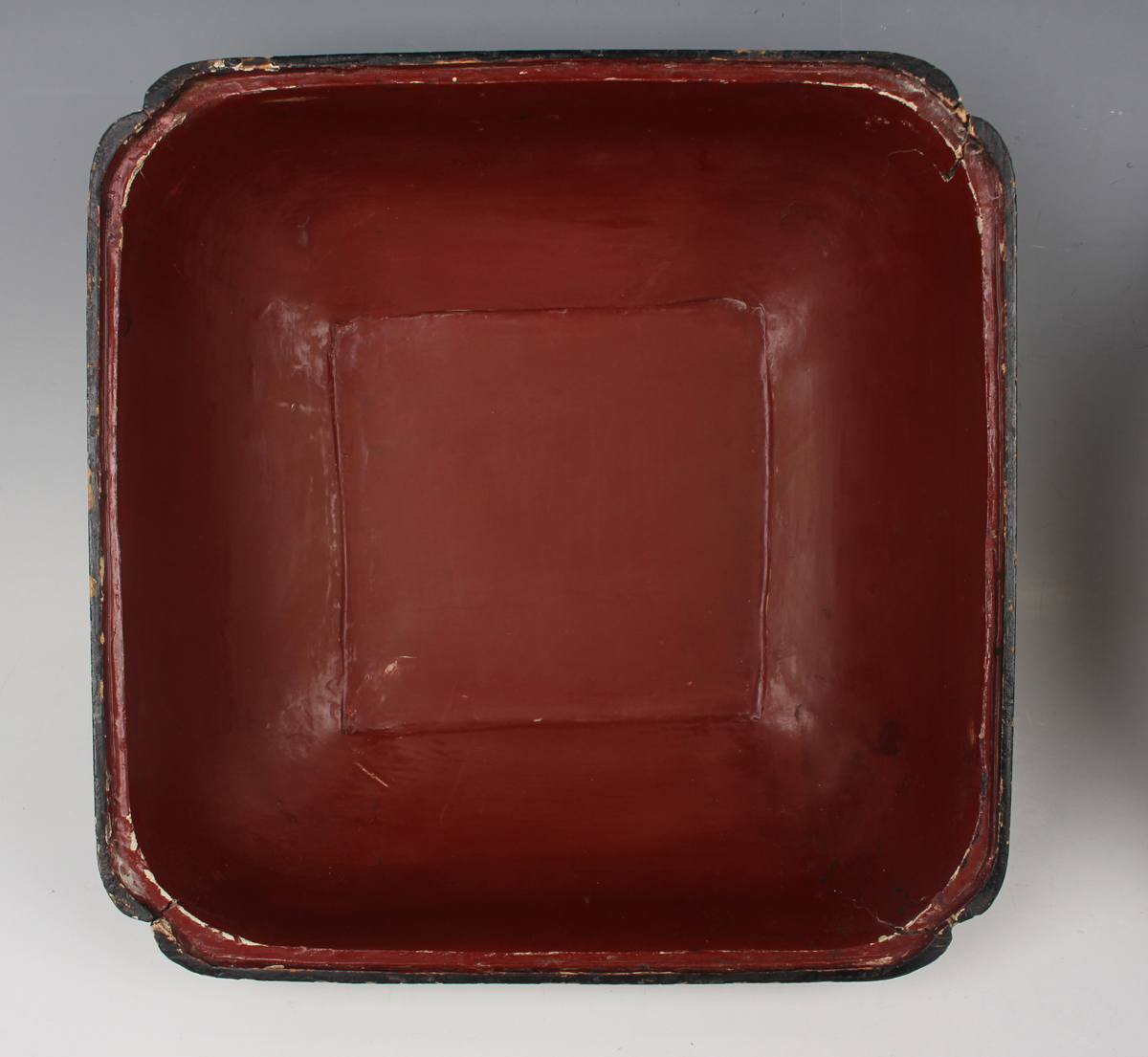 A Chinese lacquer box and cover, late Qing dynasty, of compressed square form, the top decorated - Image 12 of 17