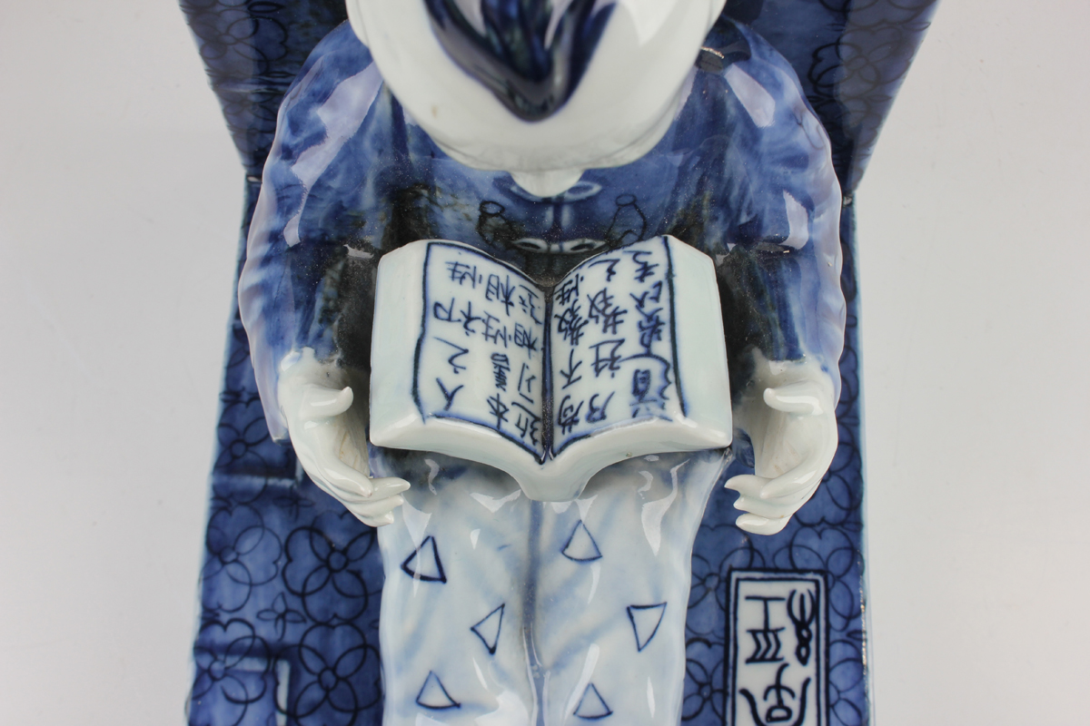 A pair of Chinese blue and white porcelain bookends, each modelled with a seated boy or girl reading - Image 6 of 18