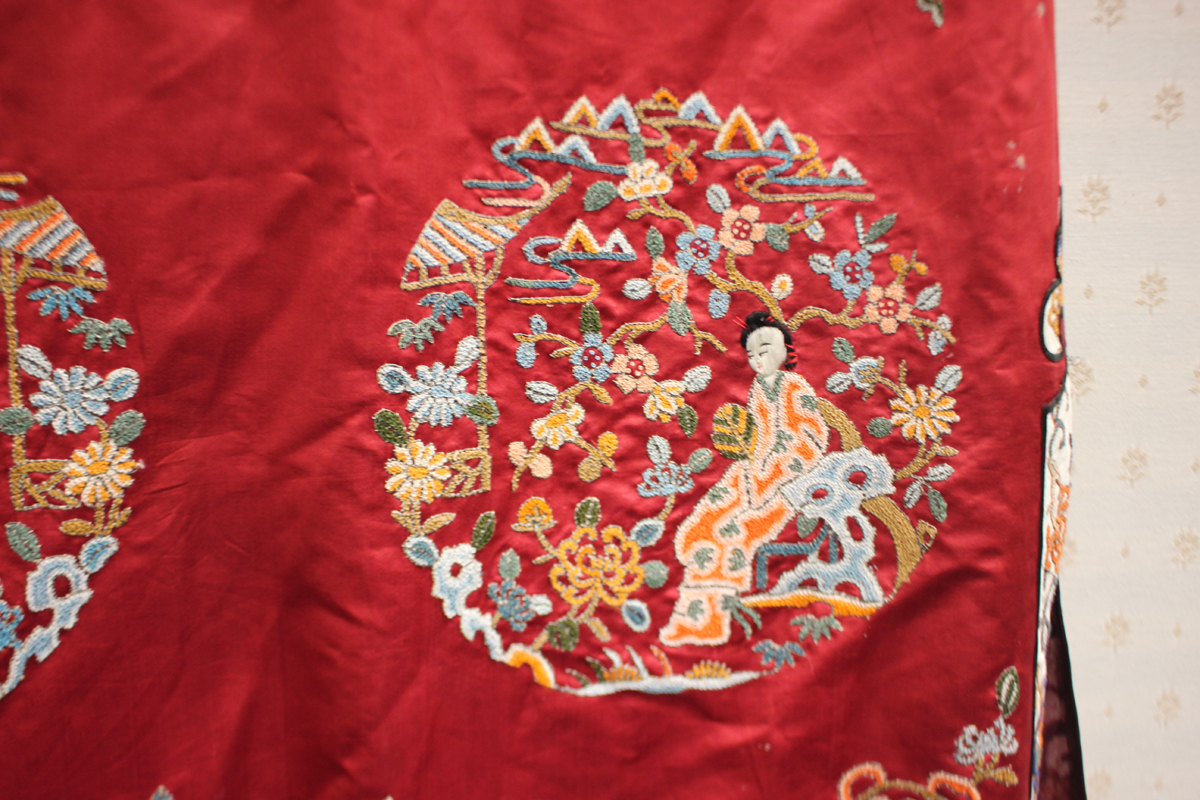 A Chinese red silk embroidered coat/robe, 20th century, worked in coloured threads with figure and - Image 7 of 19