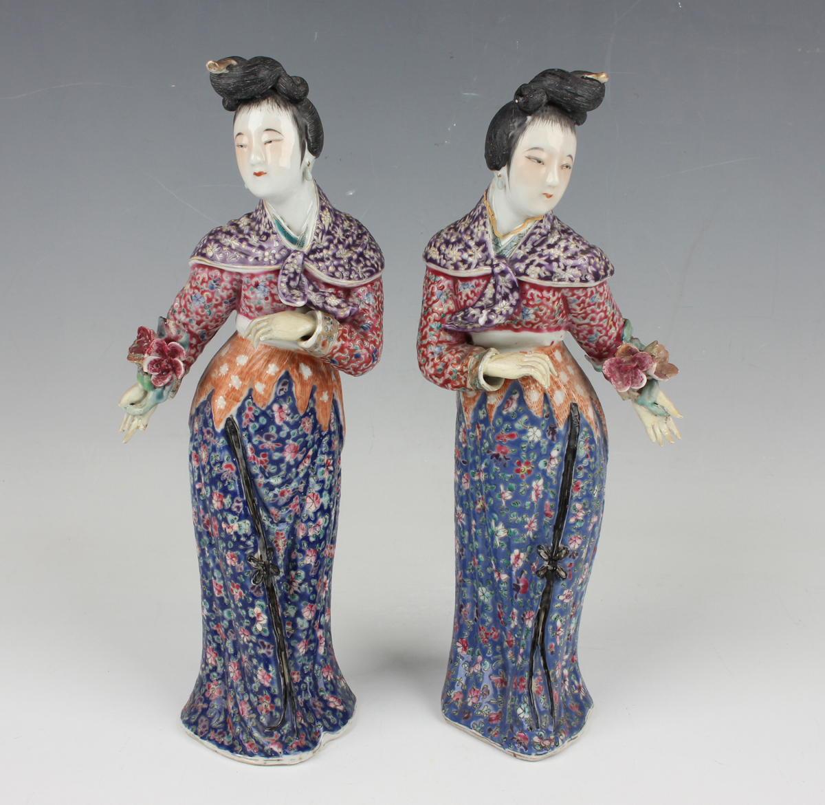 A pair of Chinese famille rose enamelled porcelain figures of maidens by Wei Hong Tai, late Qing