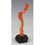 A Chinese carved coral figure of a maiden, late Qing dynasty, the slender figure finely carved