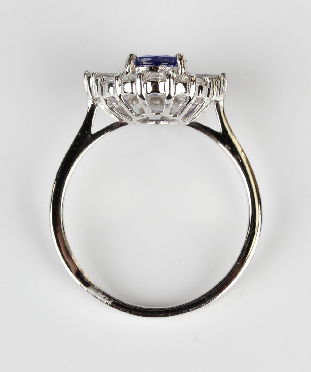 A white gold, tanzanite and diamond cluster ring, claw set with an oval cut tanzanite within a - Image 3 of 5