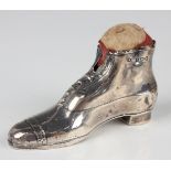 A George V silver novelty pin cushion in the form of an ankle boot, Birmingham 1913 by Crisford &