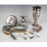 A late George II silver cream jug of low-bellied form with scroll handle, raised on scroll legs,