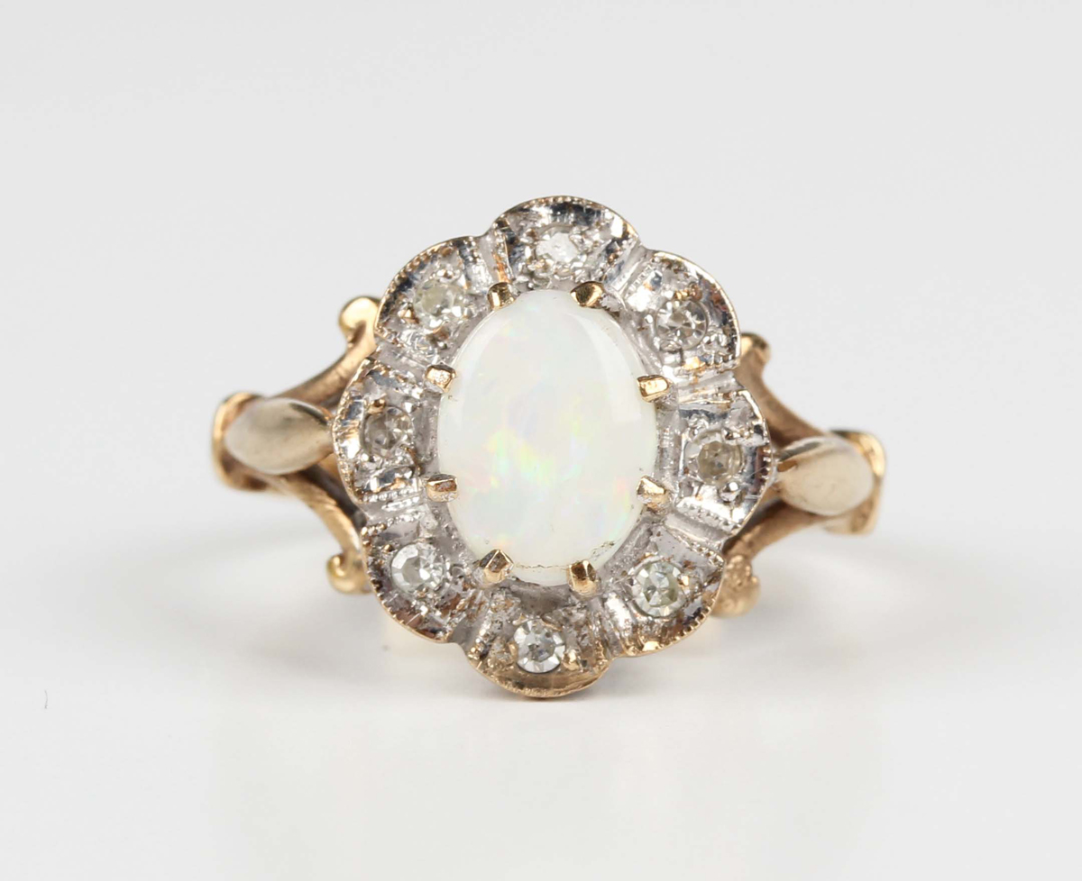 A 9ct gold, opal and diamond shaped oval cluster ring, claw set with the oval opal within a surround - Image 5 of 5