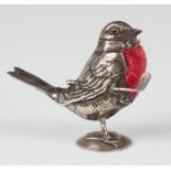 A George V silver novelty pin cushion, modelled in the form of a robin holding a golf club under its