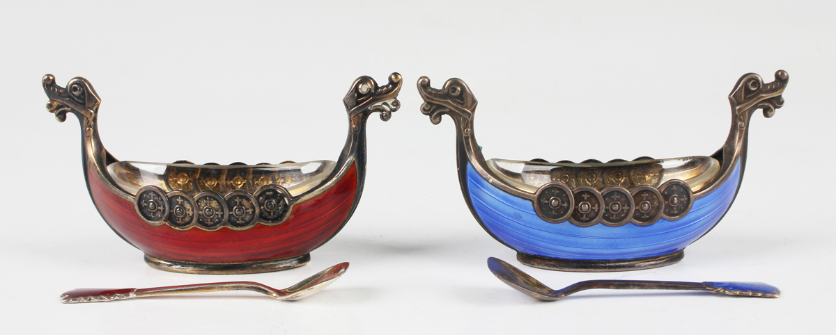 A pair of 20th century Norwegian sterling silver and enamelled longboat salts and spoons, one