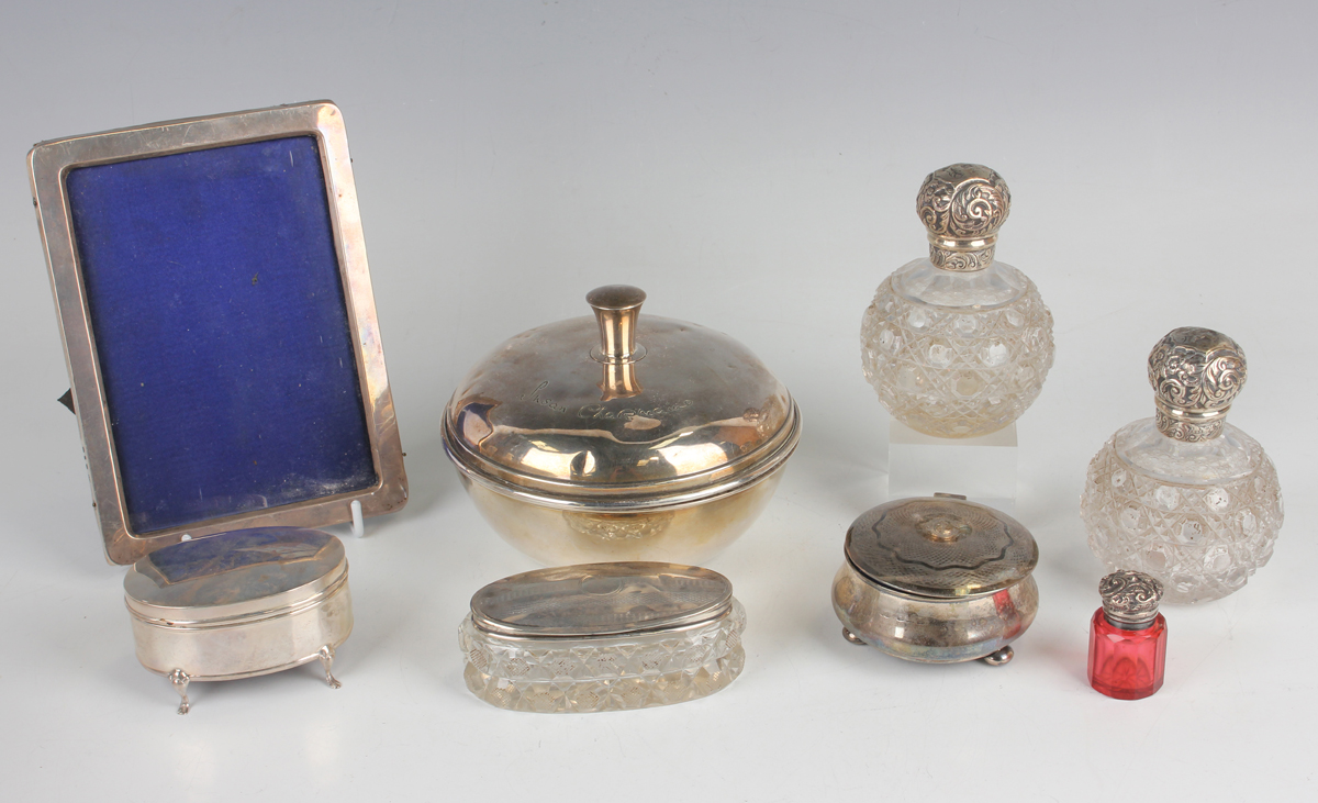 A group of silver and silver mounted dressing table items, including a circular powder jar and