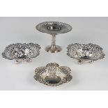 A pair of late Victorian silver shaped square bonbon dishes, each with pierced sides and floral