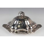 An early Victorian silver entrée dish and cover, the shallow dish with cast foliate scroll,