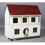 A white painted wooden doll's house, mid-20th century, the balconied front opening to reveal a