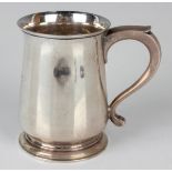A George VI silver christening tankard of tapering form with scroll handle, on a circular foot,