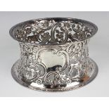 An Edwardian Irish silver dish ring, pierced and embossed with dogs and birds amongst flowers and