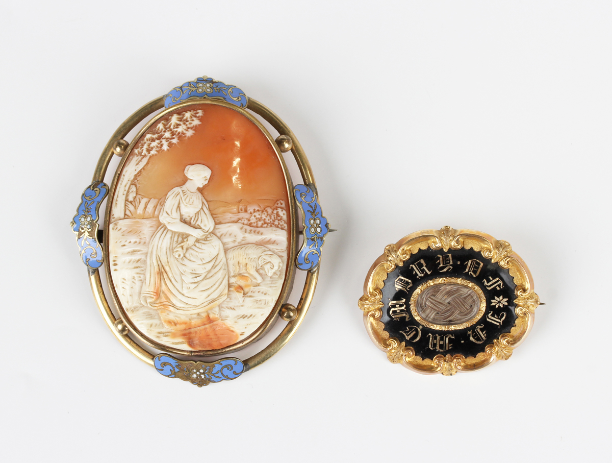 A Victorian black enamelled shaped oval mourning brooch, mid-19th century, glazed with a central