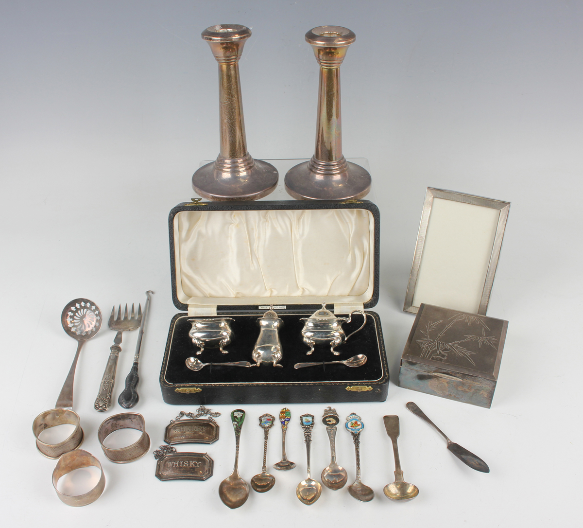 A collection of assorted silver, including a pair of candlesticks, Birmingham 1953, a Hong Kong