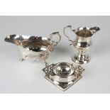 A George III silver baluster cream jug with shaped rim and scroll handle, on a circular foot, London