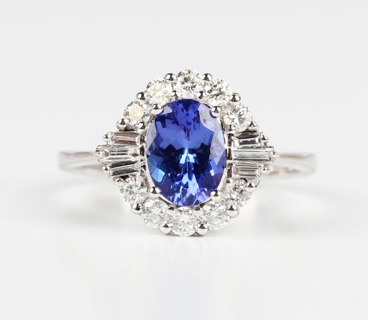 A white gold, tanzanite and diamond cluster ring, claw set with an oval cut tanzanite within a - Image 5 of 5