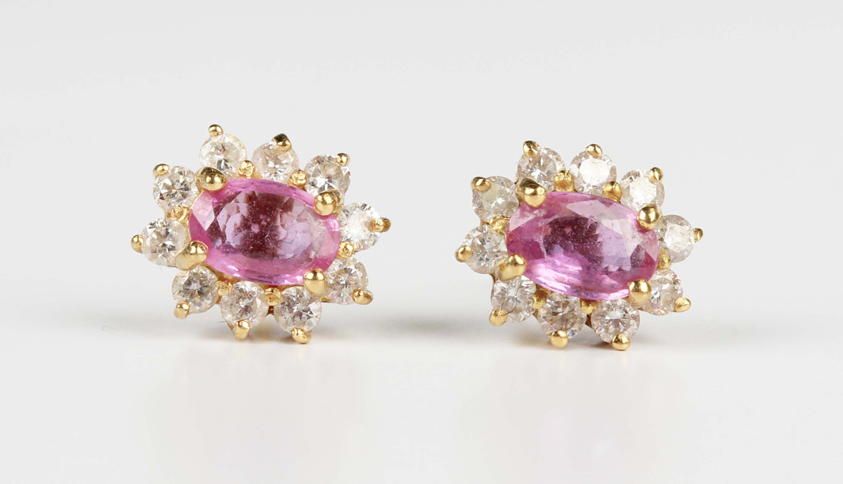 A pair of 18ct gold, pink sapphire and diamond oval cluster earstuds, each claw set with the oval