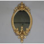 A Victorian gilt gesso oval girandole wall mirror, fitted with three candleholders, height 105cm,