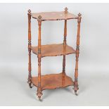An early Victorian mahogany three-tier whatnot with turned supports and brass castors, height