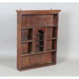 A 18th century and later provincial oak wall shelf with central arched niche, height 99cm, width