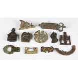 A collection of Anglo-Saxon copper alloy artifacts, including three stirrup mounts, a group of