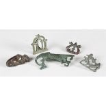A group of five Roman and other ancient copper alloy brooches, including fighting gladiators, a