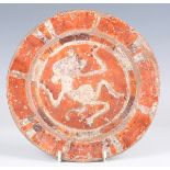 A Mexican pottery plate, probably Mixtec civilization, circa 1100-1400 AD, painted in red and orange