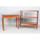 A mid-Victorian mahogany three-tier whatnot with barley twist supports and a cushion frieze