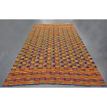 A large Ashanti kente cloth with twenty vertical stripes of polychrome geometric decoration, 344cm x