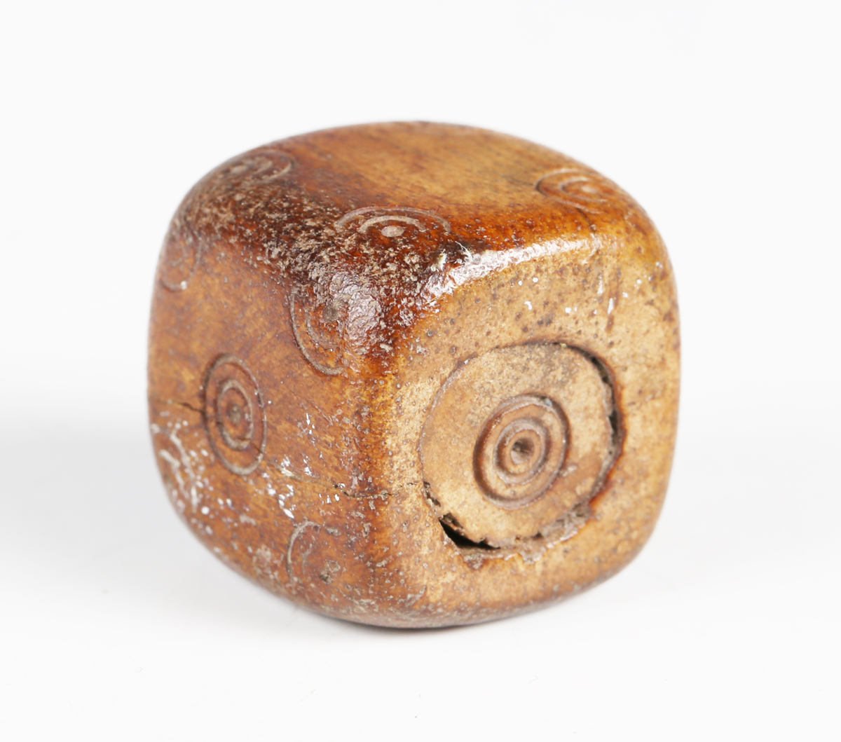 A Roman bone di, each side finely incised with roundels, width 1.8cm.Buyer’s Premium 29.4% (