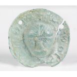 A Romano British or Anglo Saxon verdigris bracteate mount, the central mask within an outer border