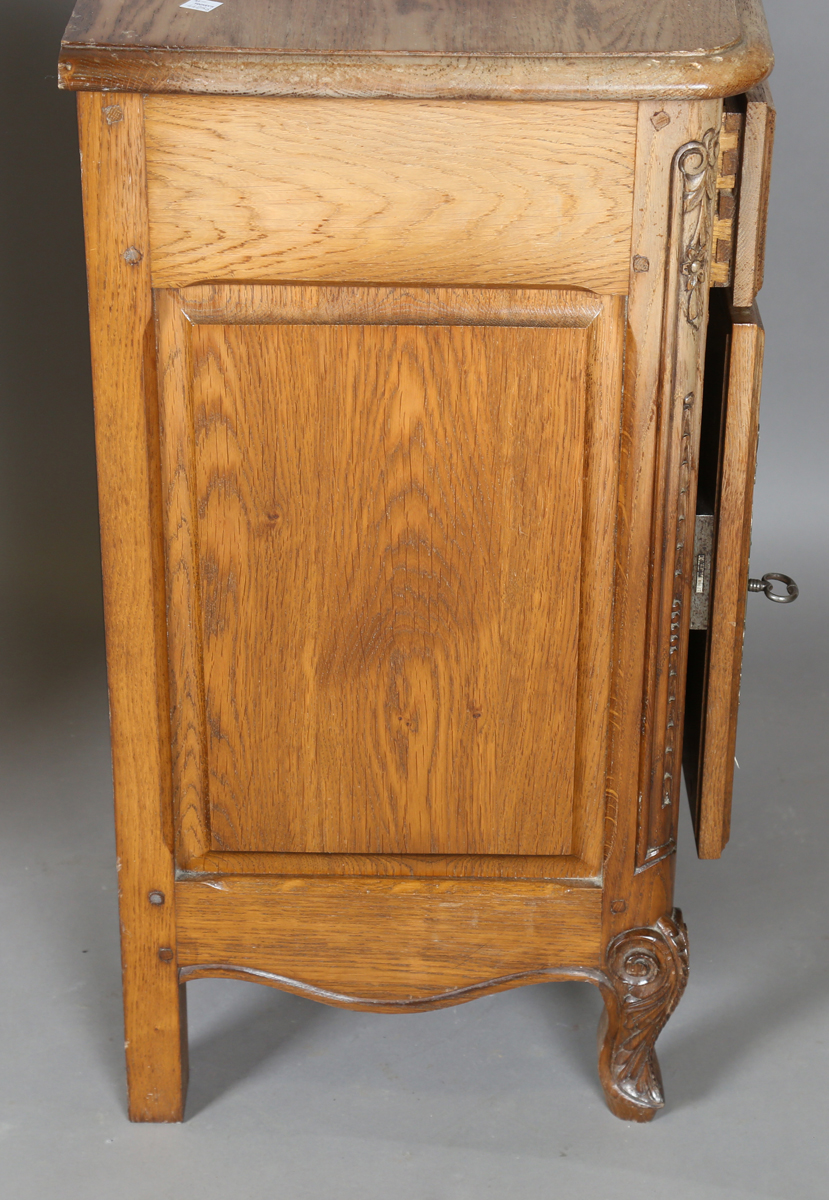 A pair of late 20th century French oak bedside cabinets, each fitted with a finely carved drawer and - Image 2 of 17